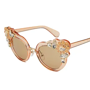 Fashionable oversized women's sunglasses featuring elegant floral rhinestone detailing on frames