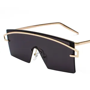 Fashionable oversized one-piece shield sunglasses with gold metal frame and dark lenses