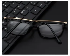 Close-up detail of retro black frame eyeglasses featuring elegant slim gold metal temples