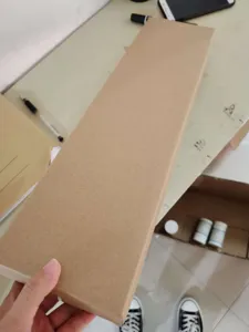 Cardboard packaging box detail for detachable weed remover tool, sturdy long brown carton.
