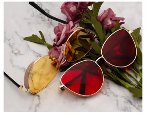 Detail of trendy sunglasses with glitter metal frames and colored mirror lenses