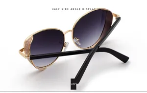 Detail of fashionable women's sunglasses with glitter frames and gold metal frame