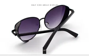 Detail of women's sunglasses with purple gradient lenses and glitter side frame accents.