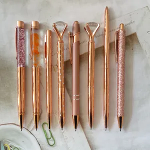 Set of 8 rose gold ballpoint pens featuring crystal diamonds, glitter, and dried flowers.