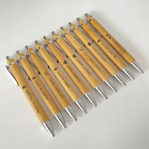 Detail shot of engraved bamboo ballpoint pens set with inspirational Bible verse quotes.