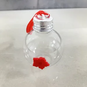 Clear plastic bulb hummingbird feeder with red flower feeding port for outdoor garden.