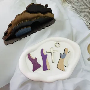 Detailed shot of wooden Easter resurrection scene decor, showing cutout figures and mountain.