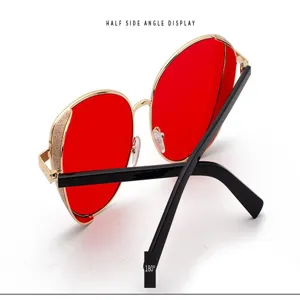 Side view of women's fashion sunglasses with red lenses and glitter gold frames