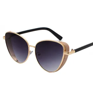 Cat-eye sunglasses with gold metal frame and sparkly glitter side shield decoration.