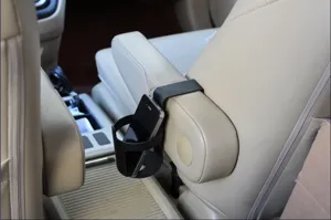 Car armrest cup holder and phone mount detail view, convenient storage organizer for vehicle.