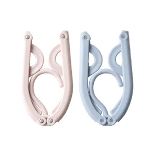 Portable foldable clothes hanger for travel and home use, multi-functional plastic drying rack.