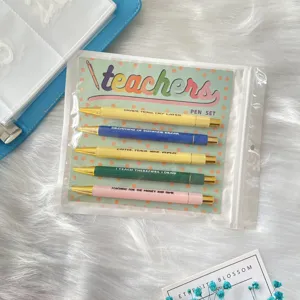 Detailed view of 5-piece teacher themed ballpoint pen set in colorful packaging card.