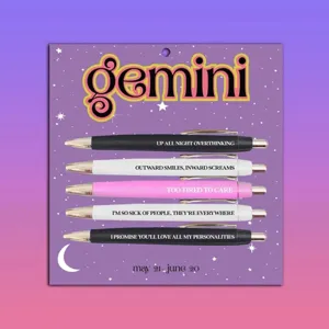 Close-up view of Gemini zodiac ballpoint pen set with five pens featuring fun quotes on a card.