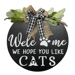 Wooden cat welcome sign with plaid bow and greenery, rustic pet door hanging decor.