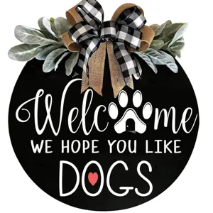 Wooden dog welcome door sign with buffalo check bow and greenery for home front porch decor.