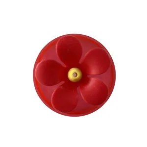 Red plastic flower replacement part for hummingbird feeder with yellow center feed hole detail