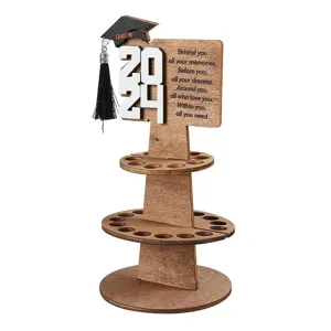 Detailed view of wooden tiered graduation money holder with cap and quote plaque.