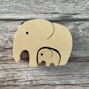 Wooden elephant figurine detail view showing mother and baby nesting design for home decor
