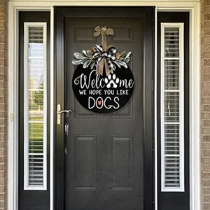 Wooden dog welcome door sign with buffalo check bow and greenery for front porch decor.