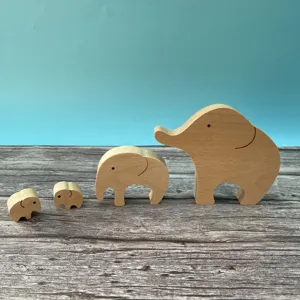 Detail view of wooden elephant mother and child figurines set, natural wood toy decor.