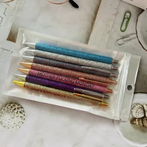 Close-up of 7pcs colorful glitter retractable ballpoint pens set with funny quote prints.