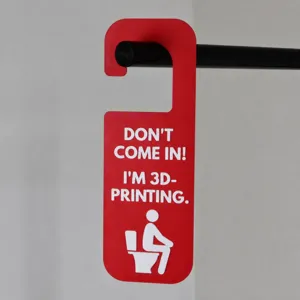 Close-up detail of the funny 3D printing door hanger with clear English lettering.