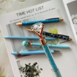 Diamond ballpoint pen with sparkling rhinestones and rose gold metal top for office school use.
