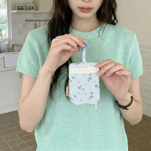 Floral print key pouch with double zipper and hanging ring for women daily use item.