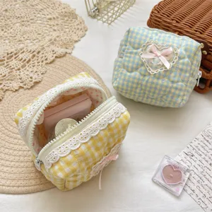 Quilted cosmetic pouch with cute lace trim and pink bow, aesthetic makeup storage bag.
