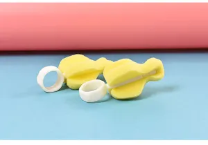 Detailed view of the yellow sponge baby bottle nipple brush featuring white ring handle clean.