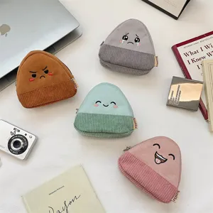 Detail showing four colorful corduroy coin purses with cute onigiri facial expressions