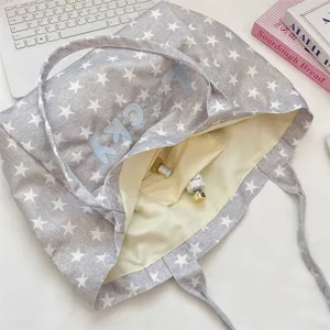 Close-up of internal pocket inside the grey star pattern canvas tote bag with embroidery