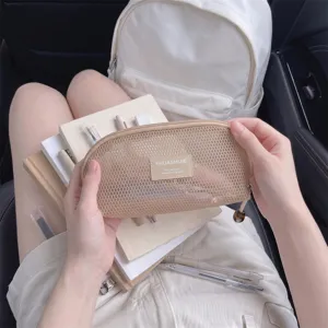 Minimalist beige mesh makeup brush storage bag shown in a lifestyle school setting.