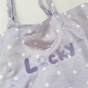 Close-up of lavender polka dot tote bag featuring Lucky embroidery and fabric texture
