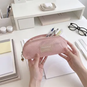 Close-up of a pink mesh shell-shaped storage bag for makeup brushes or pens