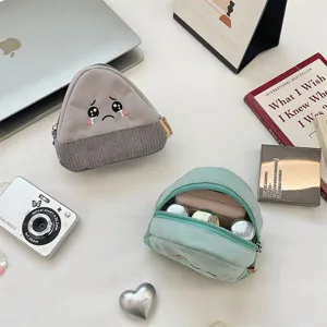 Detailed view of cute onigiri coin purse with corduroy texture and embroidered sad face