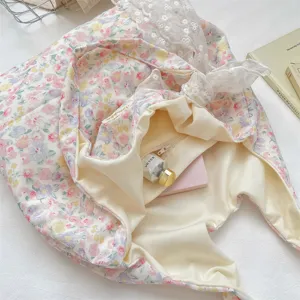 Floral tote bag detail showing internal zipper pocket and lace decoration