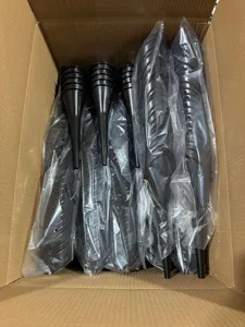 Detailed view of stacked black plastic long-mouth funnels packed inside a carton.