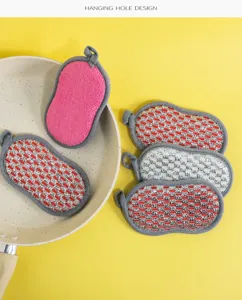 Double-sided cleaning sponge detail view, kitchen scouring pad with convenient hanging hole.