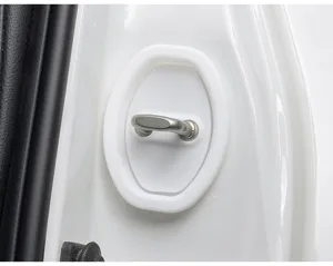 Car door lock protection pad detail shot, white silicone shock absorbing cover close-up view.
