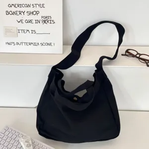 Bolso tote de lona negra de gran capacidad con correa ancha para el hombro