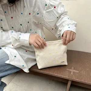 Detail view of the embroidered bow and heart pattern on the Japanese style makeup bag