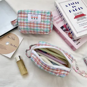 Detailed view of quilted checkered cosmetic bag showing interior storage capacity