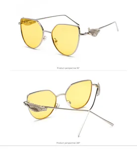 Two-view detail of retro silver sunglasses with carved wing decor and yellow lenses