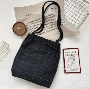 Detailed shot of vintage dark grey plaid canvas tote bag in an aesthetic lifestyle scene