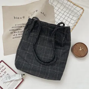 Retro dark grey grid canvas drawstring tote bag in an aesthetic flat lay arrangement