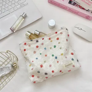 Gedetailleerde textuur van de kleurrijke organza make-uptas met zachte franjes