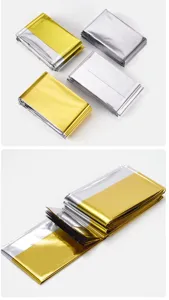 Detailed view of emergency survival Mylar thermal blankets, gold and silver foil, outdoor gear.