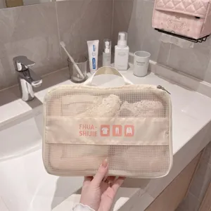 Portable beige mesh travel organizer bag for clothing storage in a bathroom setting