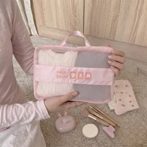 Detailed view of pink mesh travel compression bag for organizing clothes on trips